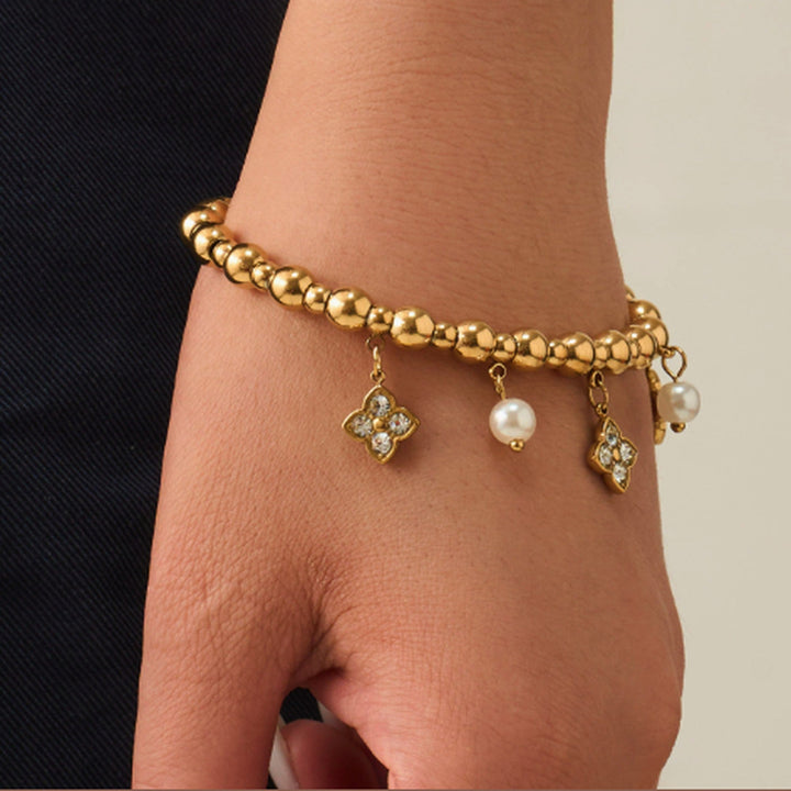 Bracelet Alba, perles dorées et breloques serties