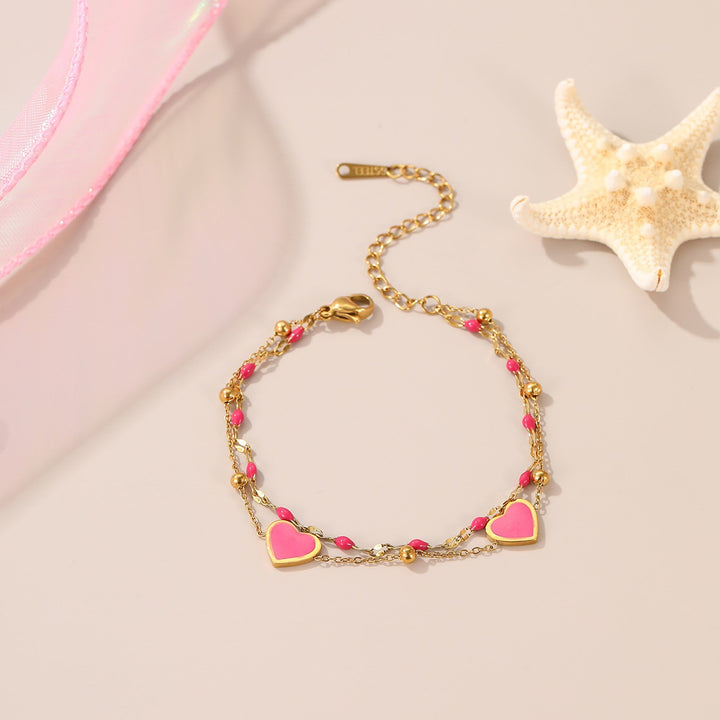 Bracelet Poppy, double rang doré et cœurs émaillés roses